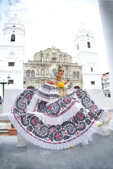 Woman in traditional costume in front of church